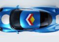 Top-down view of a blue Zagato AGTZ Twin-Tail #2 sports car with white circular decals and a geometric arrow design in red, blue, yellow, and white on the hood—now joining Christian Von Koenigsegg's car collection.