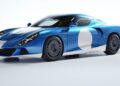 The Zagato AGTZ Twin-Tail #2, now part of Christian Von Koenigsegg's car collection, is a blue sports car with white racing stripes and circular decals, featuring a sleek aerodynamic design and dark alloy wheels, parked in a well-lit studio.