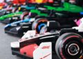 Several LEGO Formula 1 race cars, inspired by the Miami Grand Prix, are lined up side by side, each representing different teams and colors. These drivable life-size F1 cars showcase the creativity and excitement of LEGO engineering.