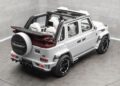 White Mansory-modified Speranza G-Class Convertible with a soft-top, black accents, exposed wheels, and a custom spare tire cover, parked in a minimalist showroom.