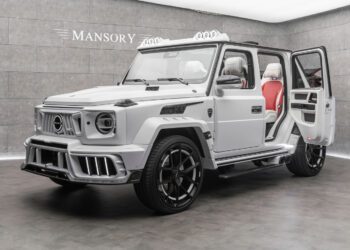 A customized white Mansory G-Class SUV with open doors, black wheels, and a striking red and white interior is displayed in a showroom, capturing the luxury style of both Mansory and the Speranza G-Class Convertible.