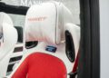 Close-up of a luxury Speranza G-Class Convertible seat with white and red leather, "MANSORY" embroidered on the headrest, and an illuminated "MANSORY" badge below it.