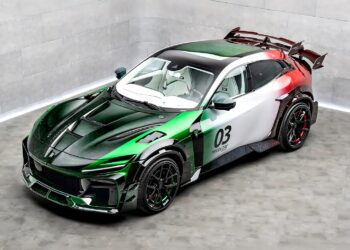 A sporty Mansory Pugnator Tricolore with racing stripes in green, white, and red, the number 03 on the door, a large rear wing, and a modern aerodynamic design is parked in a concrete room.