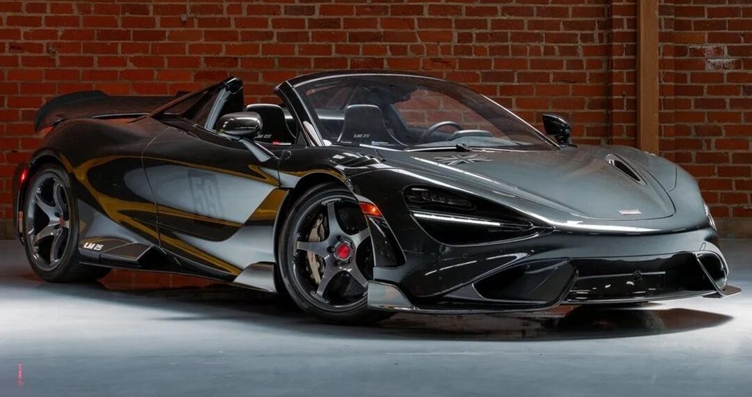 A black McLaren 720S Spider with the roof down is parked indoors in front of a brick wall, exuding the racing heritage seen in icons like the LM25 and the McLaren 765LT Spider.