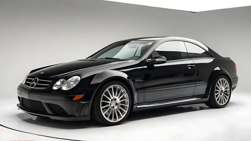 A black Mercedes-Benz coupe, one of the best used cars for 100000, is parked in a white studio, viewed from the front left side.