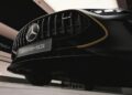 Close-up view of the front grille and badge of a black Mercedes-AMG GT 63, highlighting the AMG logo and Mercedes emblem—reminiscent of the style seen in the upcoming Brad Pitt F1 film under bright indoor lighting.