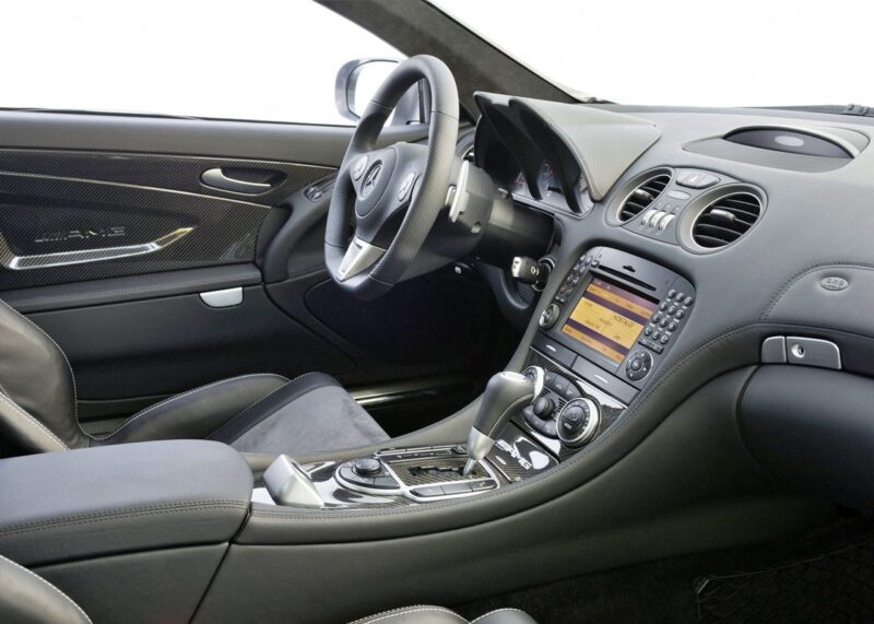 Interior view of the only Mercedes-AMG Black Series to feature a V12, showcasing a leather-wrapped steering wheel, a center console with controls, and a digital display on the dashboard.