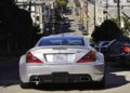 A silver Mercedes-Benz SL65 AMG—the only Mercedes-AMG Black Series to feature a V12—is parked on a street with a steep hill and residential buildings in the background.