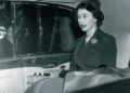A woman dressed formally sits in the backseat of a Rolls-Royce Phantom, with a reflection visible in the window beside her—echoing the elegance often associated with celebrity owners.