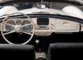 Interior view of a classic convertible car showing a white steering wheel, vintage dashboard controls, and a manual gear shift lever—offering a glimpse into how this BMW went from bold gamble to blue-chip classic.