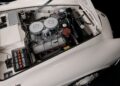 Top view of a classic BMW sports car engine bay with dual carburetors and a white exterior, showing how this BMW went from bold gamble to blue-chip classic through meticulous engineering.