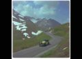A classic Rolls-Royce Phantom drives on a winding mountain road with patches of snow on the hillsides and a partly cloudy sky overhead, echoing the glamour of its celebrity owners over 100 years.