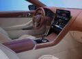Modern car interior featuring a two-tone dashboard, digital display, touchscreen controls, and leather seats, with the BMW logo visible on the steering wheel—perfectly complementing the sporty elegance of a BMW Shooting Brake.