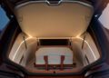 Open BMW trunk with an overhead light, displaying a single beige and brown travel bag neatly placed inside the Shooting Brake’s spacious storage compartment.
