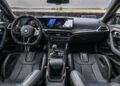 Interior of the 2026 BMW M2 CS sports car featuring a digital dashboard, large touchscreen display, leather seats, and carbon fiber accents—all designed to match its thrilling 523HP performance.