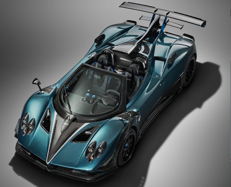A metallic teal Pagani Unico roadster with black accents and a large rear wing, viewed from above on a neutral background.