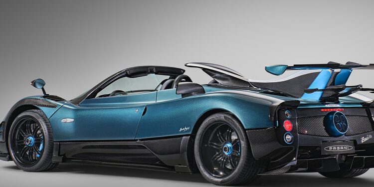 A blue and black Blue Carbon Zonda Roadster is shown angled from the rear, highlighting its aerodynamic design and carbon fiber details—a stunning 1-of-1 Pagani Unico masterpiece.