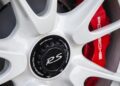 Close-up of a white alloy wheel with "RS" center cap and red Porsche brake caliper, hinting at the last production Porsche with a naturally-aspirated Mezger flat-six engine behind its iconic spokes.