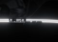 Close-up of illuminated "959" badge and thin horizontal light strip on the dark, exotic surface of a Porsche 963 RSP.