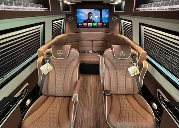 Van Van Van Interior with brown leather seats, wooden floors, window defects and a large screen TV showing a movie in the front. Emblements Mercedes-Benz lights up to head baccalaureate-ideal for those looking for executive or luxurious RVS for sale.