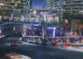 A nighttime city racetrack scene with neon lights, racing cars on a curved track, and modern buildings in the background—this upcoming F1 track’s opening corner is 20 storeys up in the sky for a truly elevated racing experience.