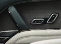 Close-up of a Range Rover SV Carmel Edition car door interior, highlighting seat memory buttons labeled 1, 2, and M, with luxurious leather and metal trim—exemplifying the exclusivity found in Exclusive Rovers.