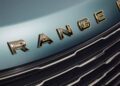 Close-up of the front grille and gold "RANGE" lettering on a light green Range Rover SV Carmel Edition, one of the most exclusive Rovers for sale.