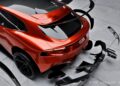A shiny red sports car is parked on a concrete surface with its detachable black body parts suspended around it. Text in the corner reads “Side.exhaust version.” RNG Design's Limited-Run Body Kit gives the Ferrari Purosangue a bespoke makeover.