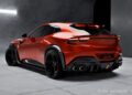 A red sports SUV with black accents and four side exhausts, featuring RNG Design's limited-run body kit for a bespoke makeover, is parked indoors on a concrete floor, viewed from the rear left angle.