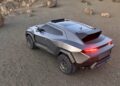 A futuristic, metallic grey SUV with angular design and off-road tires parked on rocky terrain—here’s what makes the Rezvani Knight an apocalypse-ready Lamborghini Urus.