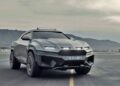 Matte gray Rezvani SUV parked on an empty asphalt surface with mountains and a cloudy sky in the background—here's what makes the Rezvani Knight an apocalypse-ready Lamborghini Urus alternative.