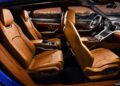 The interior of a luxury car with four tan leather seats, a modern dashboard, and city lights visible through the windows—here’s what makes the Rezvani Knight an apocalypse-ready Lamborghini Urus.