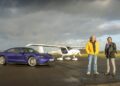 An Emotional Homecoming: James May and Richard Hammond stand on an airstrip in front of a white small airplane and a blue car under a cloudy sky, ready to race to the Top Gear track in EVs.