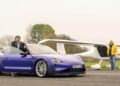 An Emotional Homecoming: James May and Richard Hammond stand beside a blue Porsche Taycan and a small white airplane on an airstrip, cloudy skies overhead, as they race to the Top Gear track in EVs.