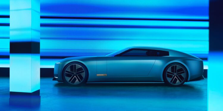 A sleek, modern Jaguar electric car, inspired by the Type 00 Concept, is parked indoors, illuminated by blue lighting and reflective surfaces like a Tokyo Art Installation.