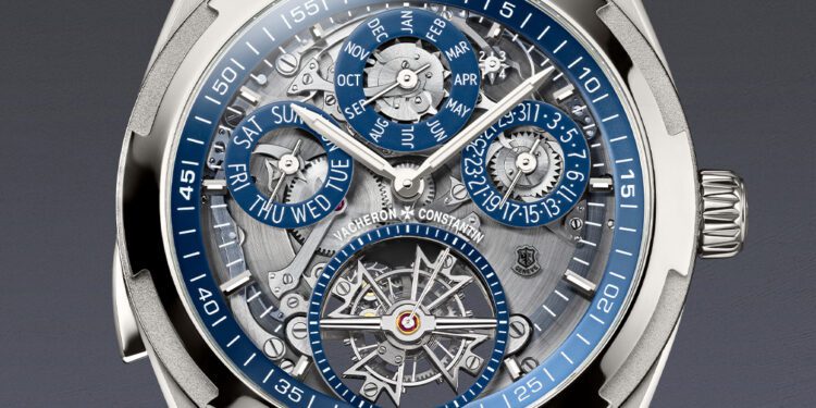 Close-up of a luxury Vacheron Constantin Overseas Grand Complication wristwatch featuring an openface intricate dial with multiple subdials for day, date, month, leap year, and a visible tourbillon mechanism.