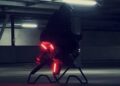 A person rides a futuristic, illuminated electric hoverbike in a dimly lit parking garage—No Wings No Rotors: So How Does The Volonaut Airbike Fly?.