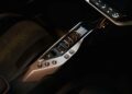 Close-up of a car’s center console featuring electronic gear selector buttons, drive mode controls, and part of a digital display screen—features you’d expect in Italy’s latest V12 supercar packing 2100+ HP and rear wheel drive.
