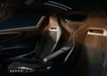 Interior of a luxury sports car—Italy’s latest V12 supercar packs quad turbos, 2100+ HP, a manual, and rear-wheel drive—featuring black bucket seats with yellow stitching, sleek controls, and a modern minimalist dashboard.