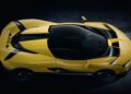 A yellow sports car viewed from above, showcasing its aerodynamic shape, black roof, and sleek design lines—Italy’s latest V12 supercar packs quad turbos for 2100+ HP, a manual gearbox, and rear-wheel drive against a dark background.