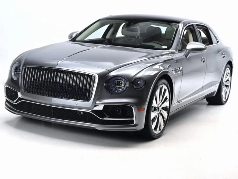A silver luxury sedan with chrome accents and large alloy wheels, this stunning model exemplifies why it’s among the best Bentleys, beautifully photographed in a studio with a white background.