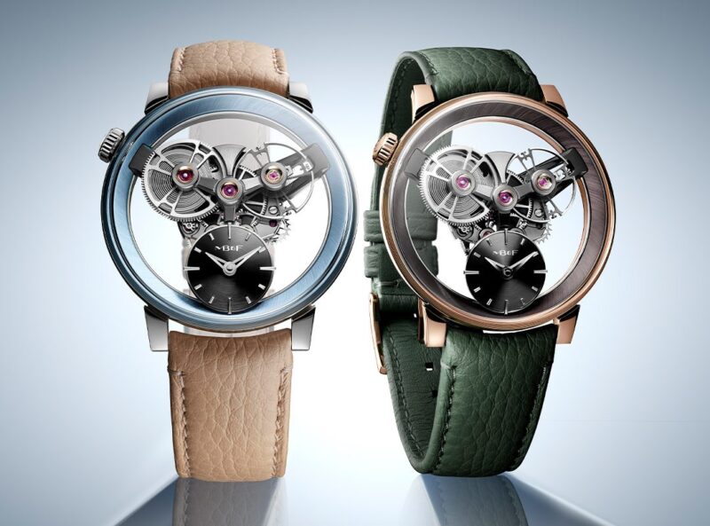 Two luxury wristwatches, including an SP One Watch by MB&F Special Projects, showcase visible mechanical movements—one with a beige strap and silver case, the other with a green strap and rose gold case—displayed elegantly side by side.