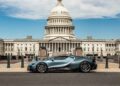 A sleek Bugatti sports car is parked in front of the United States Capitol building on a clear day, as if ready to drive straight from a Washington D.C. showroom.
