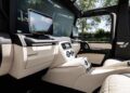 Experience the opulent interior of the Mercedes-Maybach G650 For Sale, featuring cream and black leather seats, quilted details, large display screens, and sunlight streaming through elegant windows.