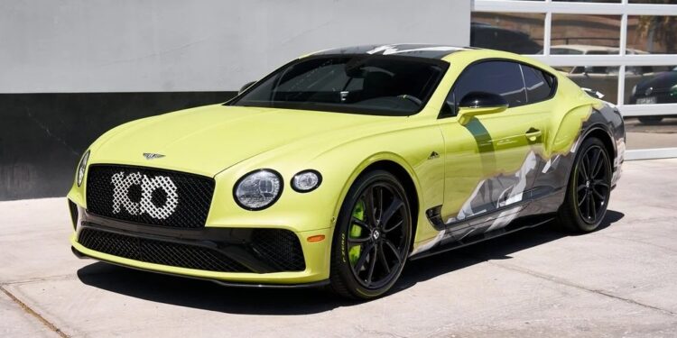 A lime green Bentley Continental GT, one of the best Bentleys, is parked on a concrete surface in front of a modern building with glass-panel garage doors.