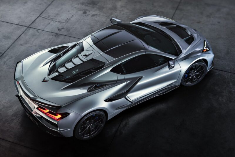A silver sports car with a sleek, aerodynamic design is parked on a concrete surface, viewed from an elevated angle—possibly the revealed 2026 Corvette ZR1X, the most powerful Chevrolet ever built.