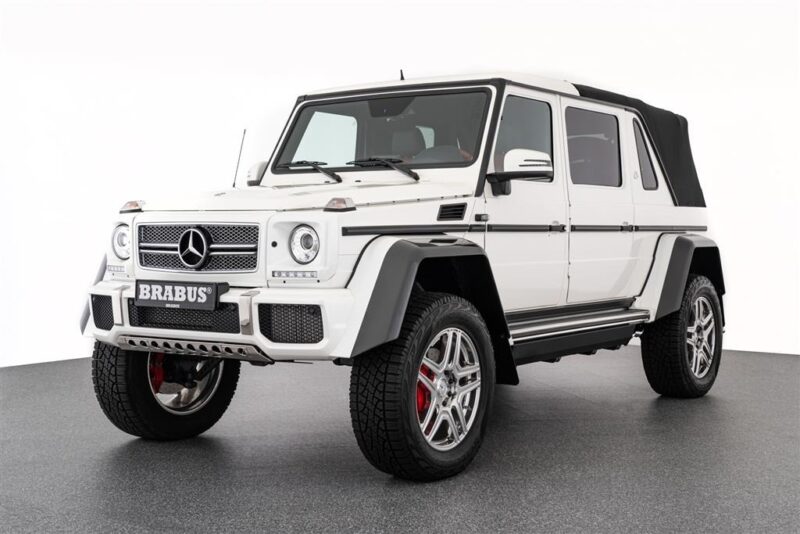 The unique white-white Brabus G-Class with a black-smooth black roof, appears in a studio on a gray white background-ideal for those looking for unique cars for their garage.