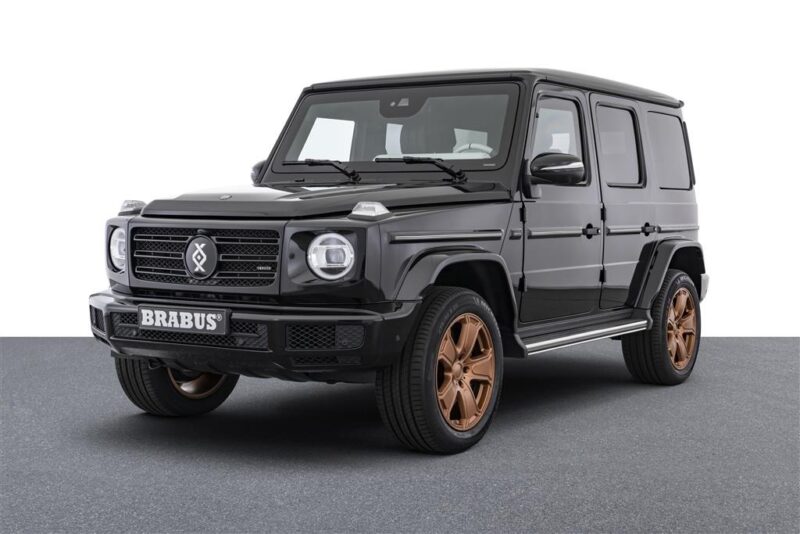 The Mercedes-Benz G-Class SUV with bronze wheels that have been modified with bronze wheels, appear on a gray surface on a white background-an ideal addition to those looking for unique cars or cars for sale.