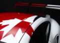 The rear section of a 911 GT3 RS sports car features a large spoiler and a red and white maple leaf design on the roof, resembling the Canadian flag, making it a standout at the Porsche Experience Center.