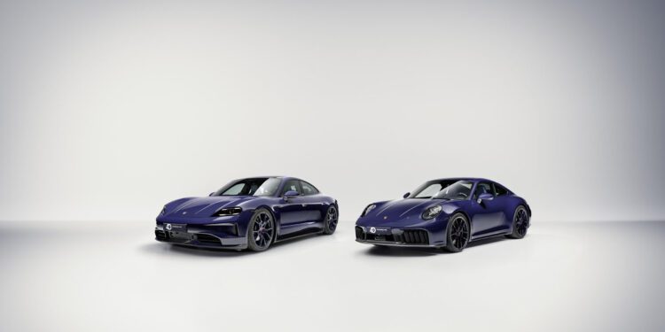 Two dark blue Porsche sports cars, evoking the luxury of Porsche Italia, are parked side by side in a minimal, well-lit studio with a light gray background.
